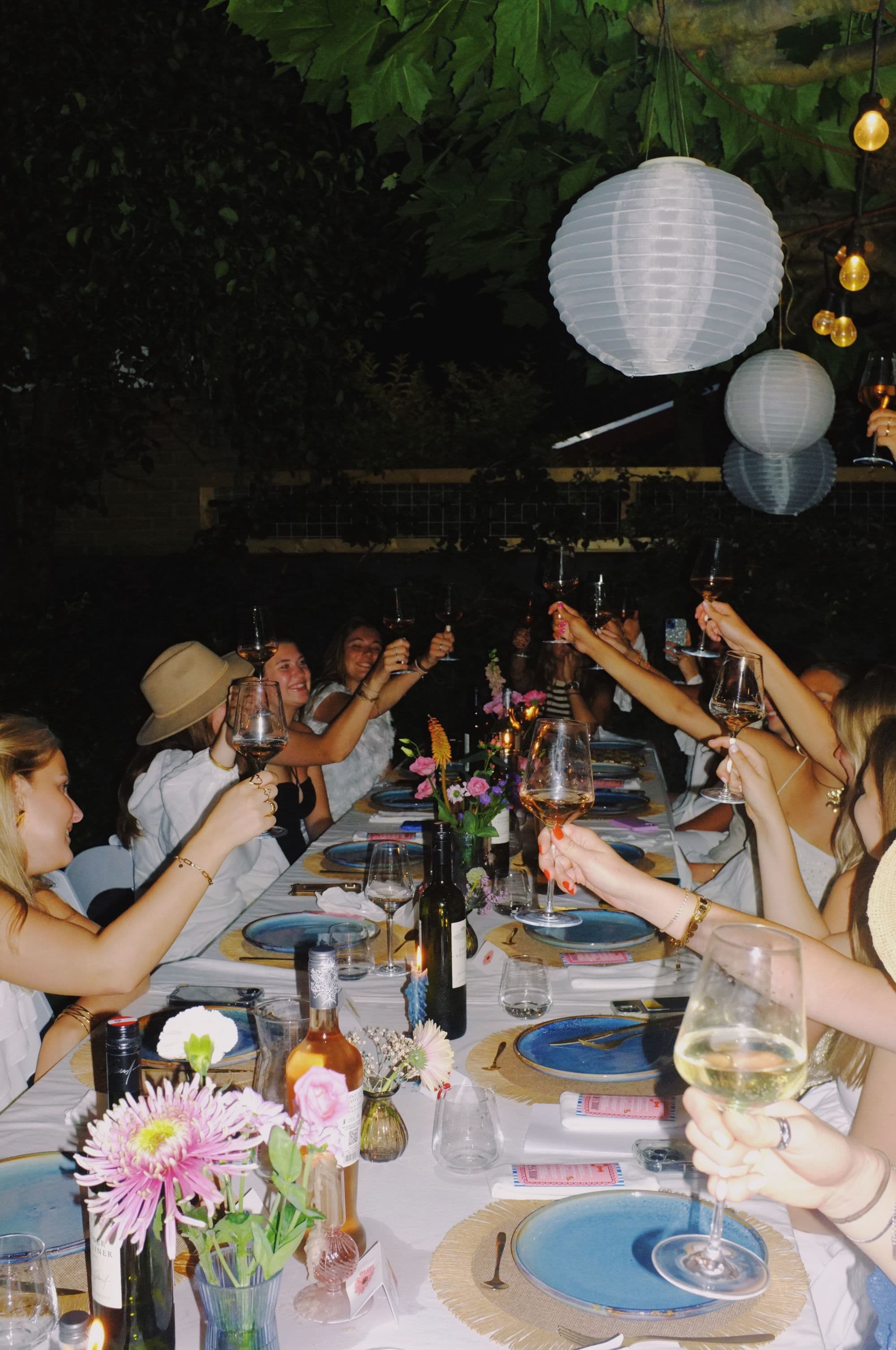Friends gathered around a long table in a garden