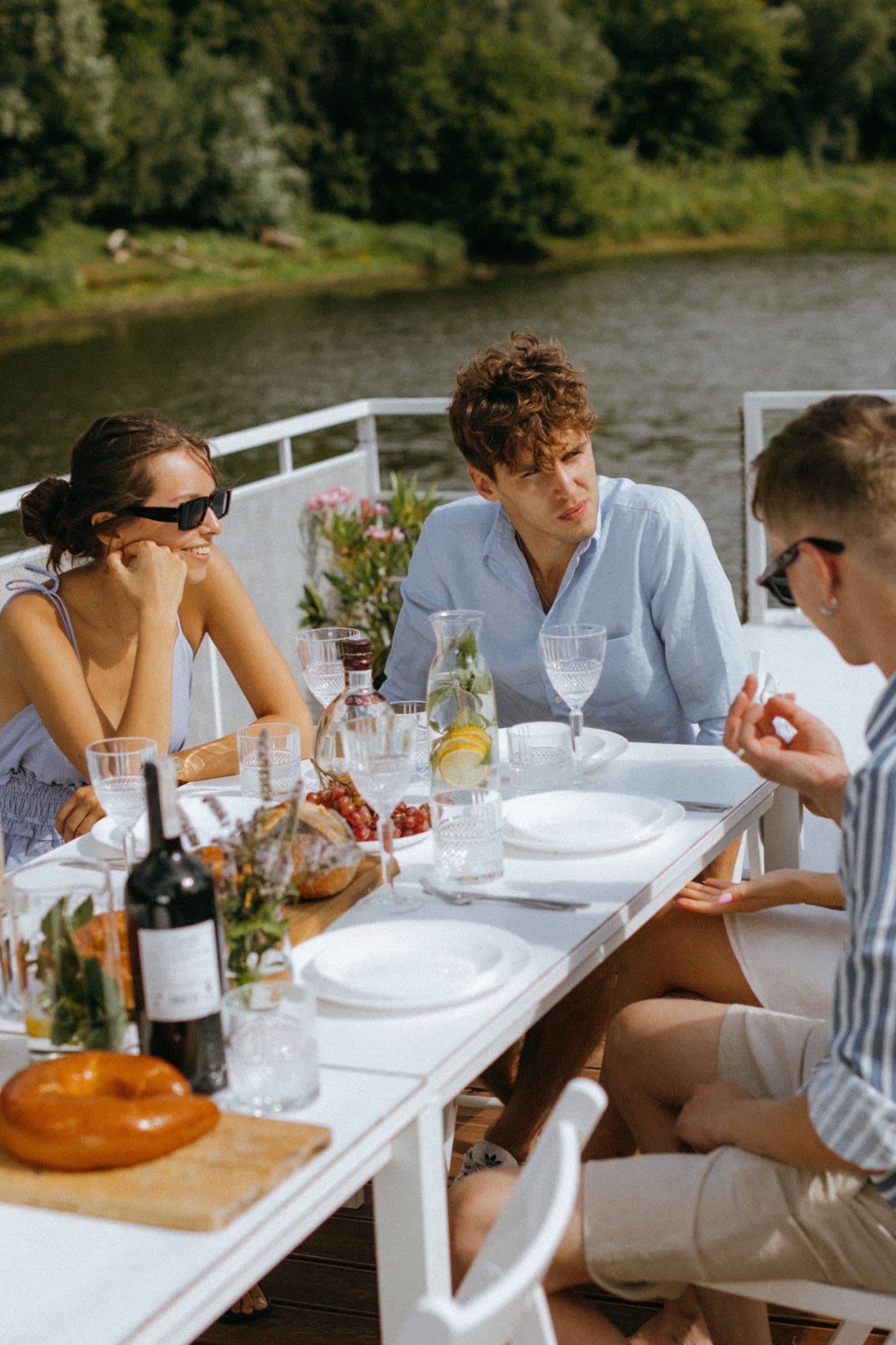 Friends eating together beside the water